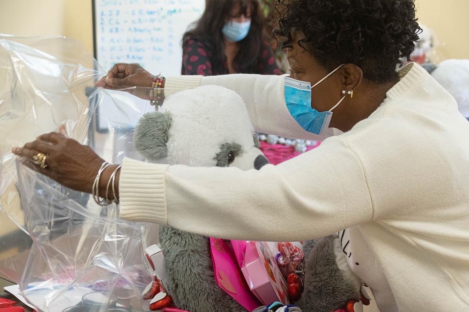 Woman making gift basket.