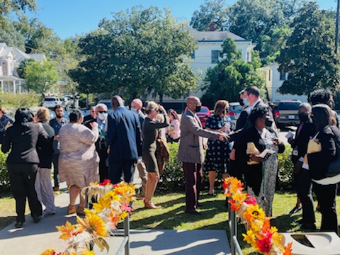 People gathering in front of the Front Porch and conversing